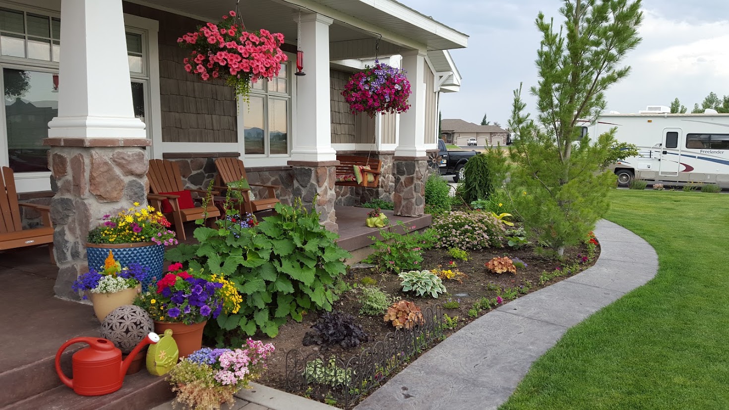 The front porch — Adirondack chairs and hanging baskets
